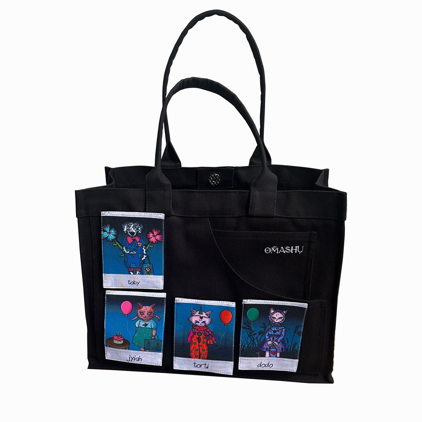 A black tote bag with five Polaroid-style patches featuring illustrated characters, including animals like a cat and a dog. The embroidered 'Omashu' logo is placed on one of the bag’s exterior pockets.