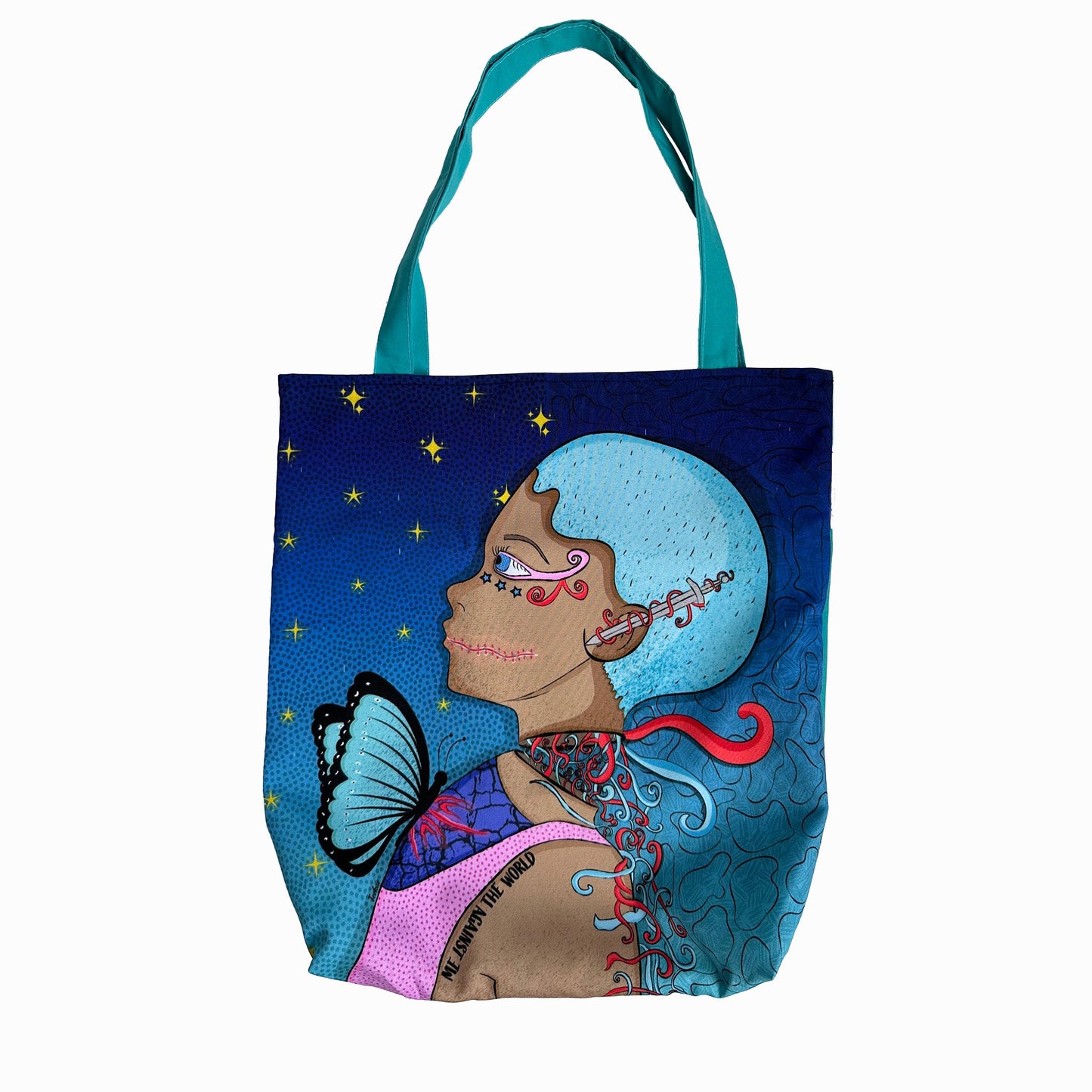 A photo of a Omashu tote bag with a colorful illustration of a woman’s profile with a blue butterfly on her shoulder and a red earring, against a dark blue background with gold stars, with blue handles.