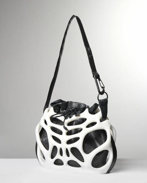 Black and white geometric handbag on a gray background
