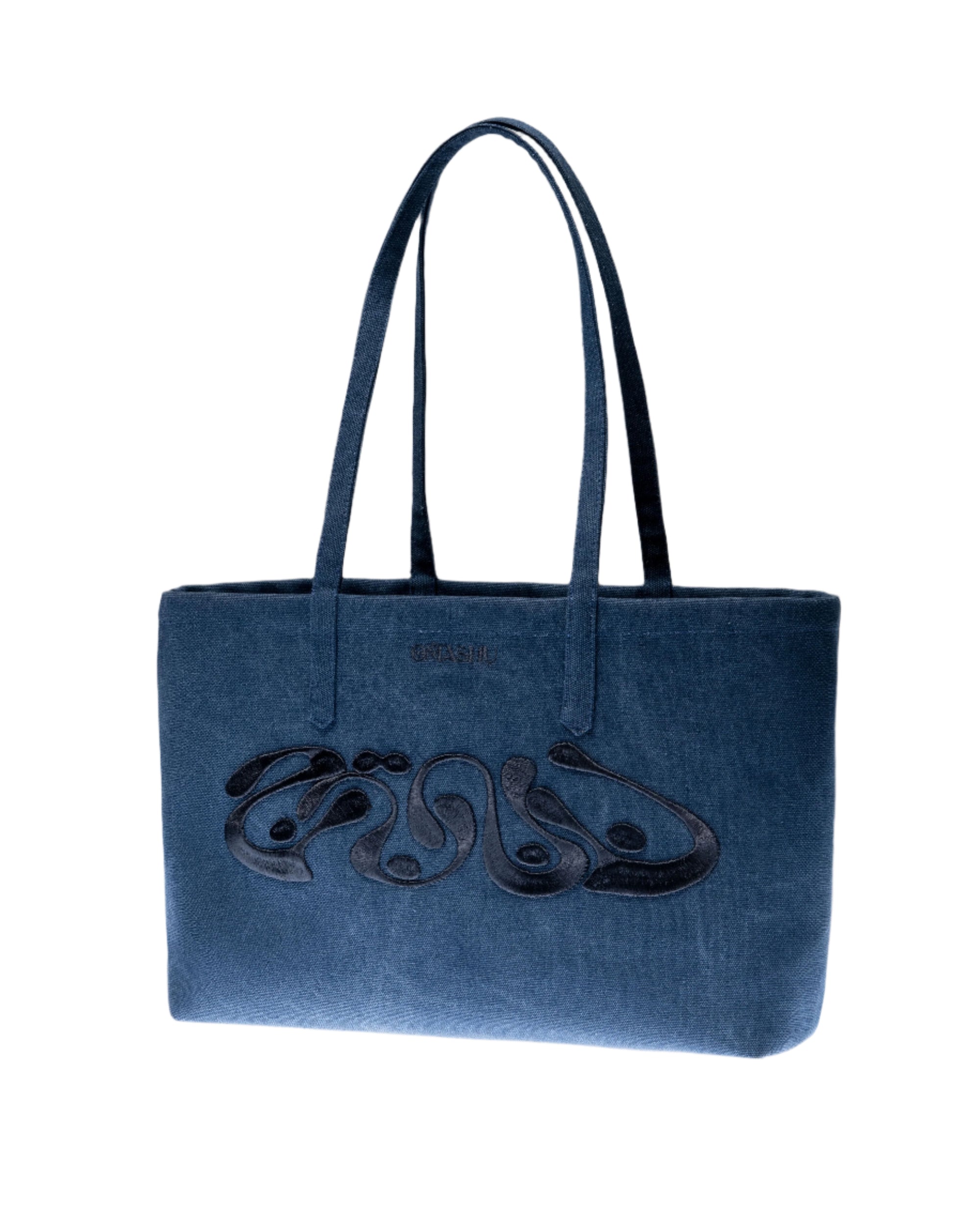 A structured blue velvet tote bag with two top handles, featuring abstract black embroidery across the front. The bag is placed against a light background for a studio shot.