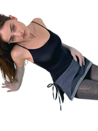 Woman wearing a black tank top and gray skirt on a white background