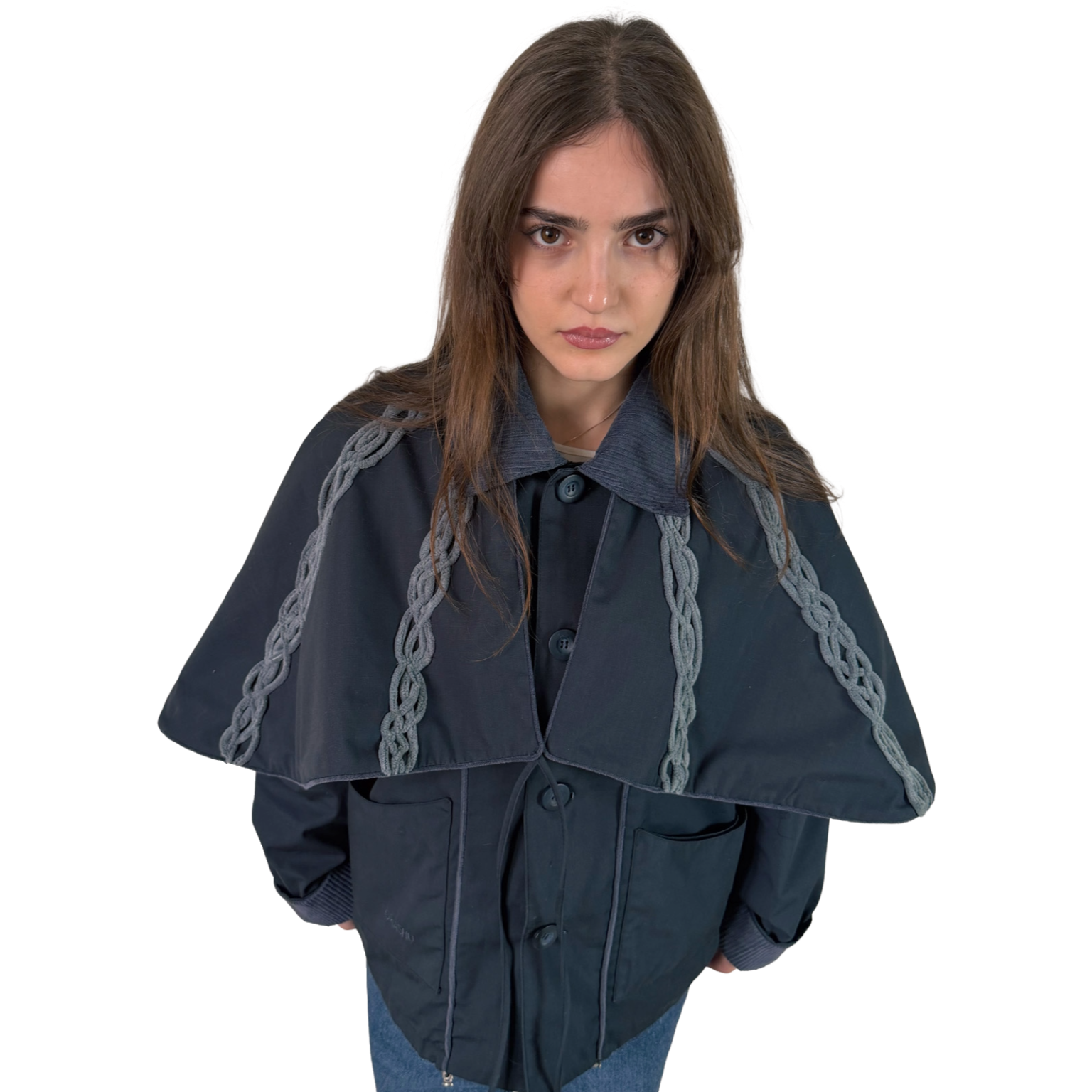 Person wearing a dark blue cape with chain details on a white background