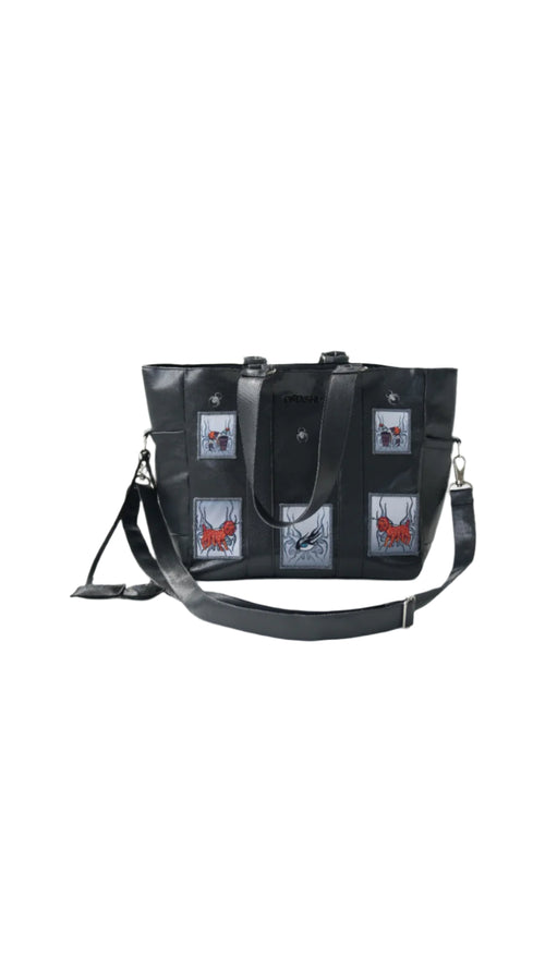 Omashu black tote bag with embroidered patches, laptop divider, and adjustable strap, showcasing bold streetwear accessory.