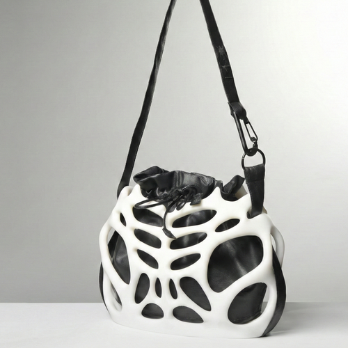 Black and white geometric-patterned bag on a gray background