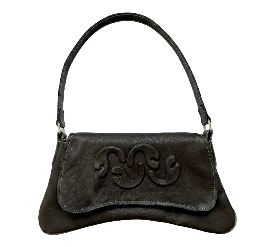 A black leather shoulder bag with a curved top handle and a large embossed monogram logo on the front flap, shown against a plain white background.