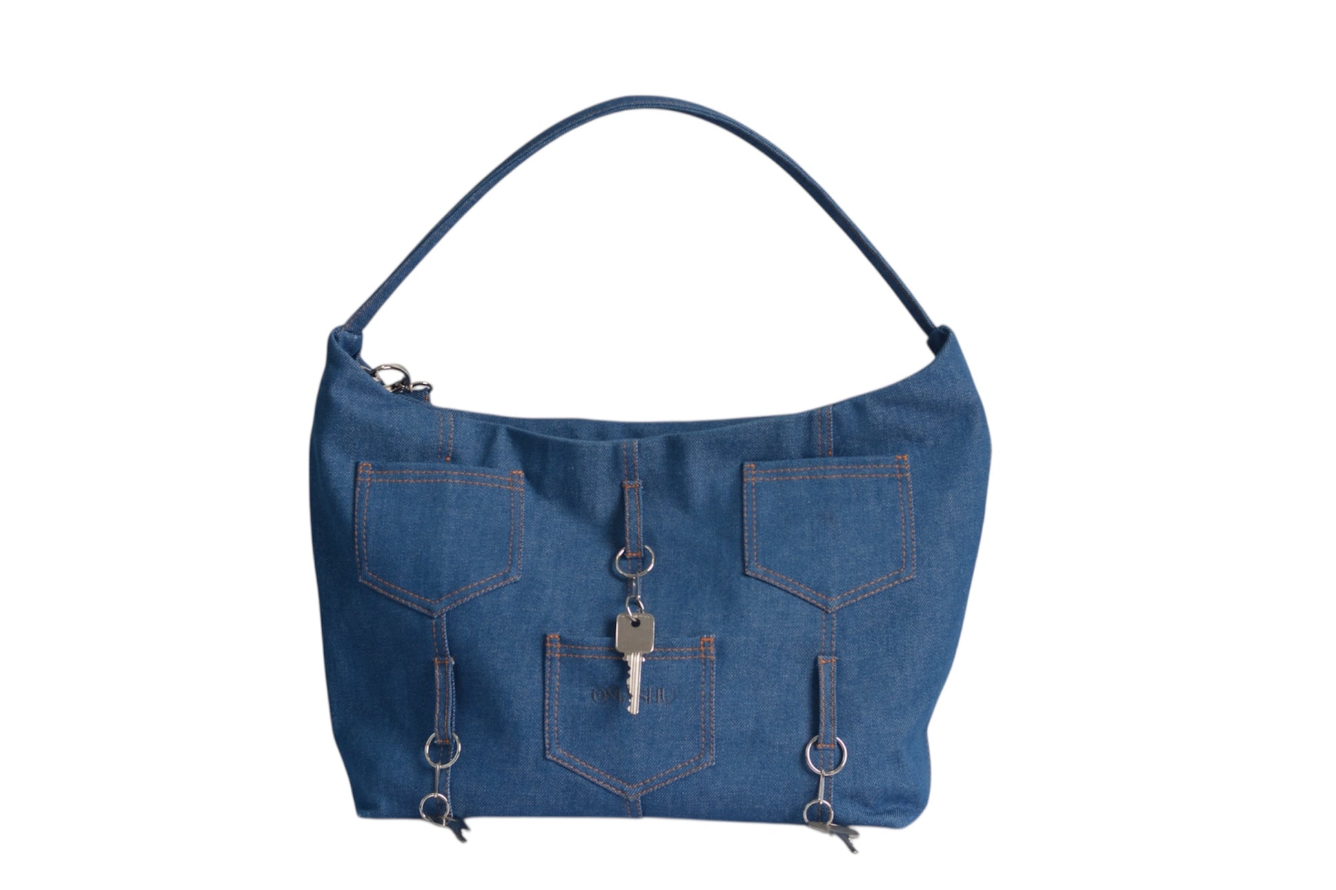 Crafted from durable blue denim, this unique shoulder bag cleverly incorporates the familiar comfort of jean pockets into its design, complete with classic orange contrast stitching. Three external pockets offer easy access to your essentials, while decorative keys dangling from D-rings add a touch of quirky charm and instantly becomes recognizable.

Details:

Material:&nbsp;Denim Exterior, Lined Interior

Hardware:&nbsp;Silver-tone metal (zipper, D-rings, key charms)

Color:&nbsp;Blue Denim

Dimensions:&nb