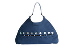 Front view of the Omashu Sylvie Eclipse Bag in blue fabric with its signature button-down 'eclipse' detail showcasing a black and white polka dot interior accent.