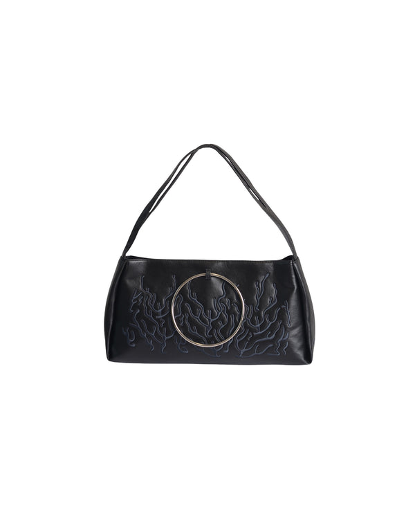 Black bag features a circular and wavy metallic embellishment on the front. Made from faux leather material.