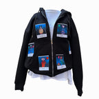 A black zip-up hoodie displayed on a mannequin, featuring six colorful Polaroid-style patches of animal characters. The characters include "Mochi," "Dodo," "Torti," "Jiyah," "Toby," and another on the back. The hoodie is shown with the zipper open, revealing a white inner layer underneath.