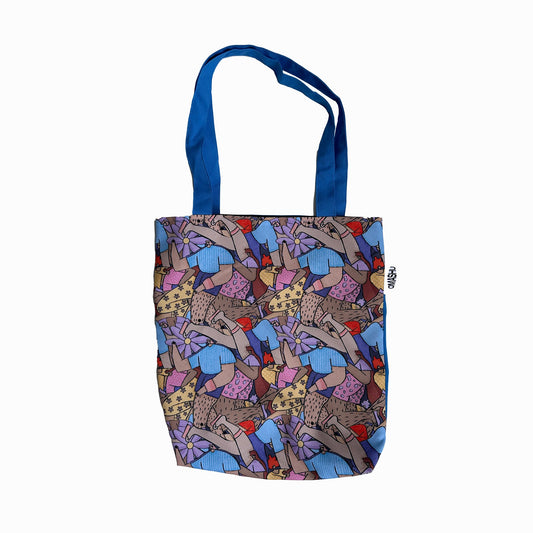 Tote bag with a colorful print. The print is a repeating pattern of blue, purple, and red birds on a beige background. The bag has a blue handle and a small white tag on the side with the letters ‘OMASHU’ written on it. The background is white.