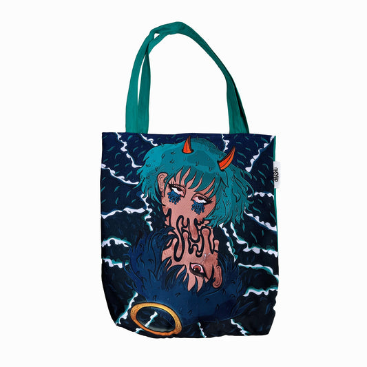 A tote bag with a graphic design on it. The tote bag is dark blue in color with a teal handle. The graphic design is of a girl with horns and a fish tail. She is holding up a peace sign with her fingers. The girl is surrounded by dark blue waves. The design is in a cartoon style. The bottom right corner of the tote bag has a goldfish in a bubble.